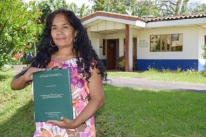 Rosemary Lopez with her master's thesis on women living with HIV