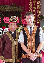Photo of two men wearing colorful clothing.