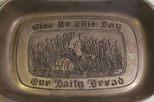 Plate that says "Give Us This Day Our Daily Bread"