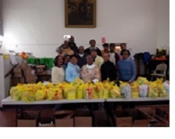 Volunteers with pastors Willie J. Keaton (third row, second from left) of Claremont-Lafayette and Gloria Tate (front row, center) of Teaneck Presbyterian with the turkey dinners to be donated