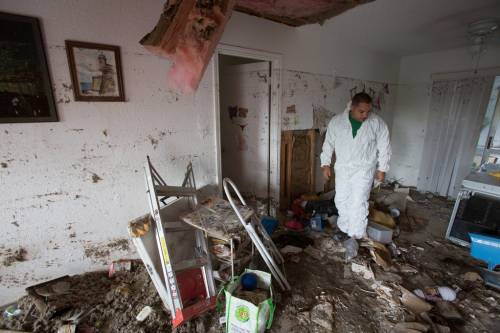 Flood survivor Willie Torres salvages property from his grandmother’s flood ravaged home in Dry Creek neighborhood in southeast Travis County, Texas. Photo by Andrea Booher/FEMA