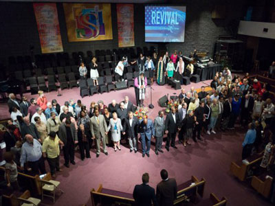 Clergy gather at the front of the sanctuary at St. Stephen Baptist church during the October 4 ‘Moral Revival’ committing to preach and act on Christian moral principles. (Photo by Gregg Brekke)
