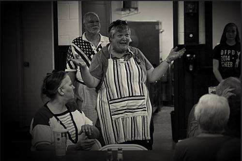 Pastor Nancy Jo Dederer offers a blessing before the community dinner at First Presbyterian Church of Homewood, Illinois. (Photo by Frank Casella)