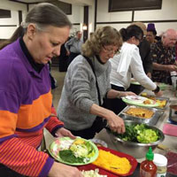Members and guests enjoy the Monday evening community dinner at First Presbyterian Church of Homewood, Illinois. (Photo by Nancy Jo Dederer)