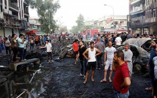People survey the damage following a deadly bombing in Baghdad's Karada market.