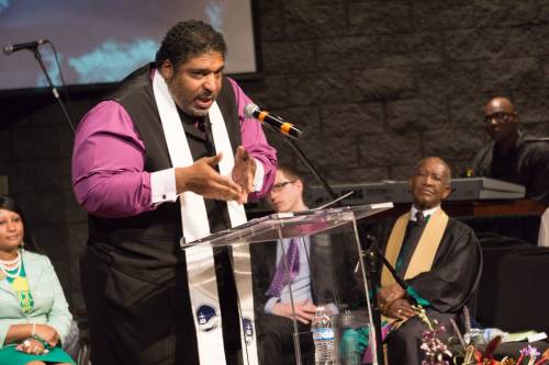 The Rev. Dr. William Barber II preaches at St. Stephen Baptist Church in Louisville during the October 4 'Moral Revival'. The Rev. Dr. James Forbes is seated, wearing stole. (Photo by Gregg Brekke)