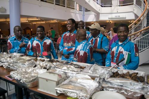 Members of the Malawi Mission Network, visiting from the Blantyre Synod in Malawi, prepare to fill their plates with authentic Malawian food. Photo by Carl Suppo.,