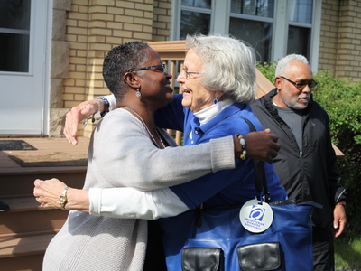 Rev. Desiree Lawson of Trinity United Presbyterian Church and Gail Farnham of PDA Disaster Response Team embrace in Flint, Mich. Photo by Mike Fitzer