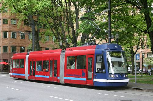 A car of the Portland Streetcar system at the eastbound Portland State University stop, on Market Street at the South Park Blocks. Photo by Cacophony, via Wikimedia