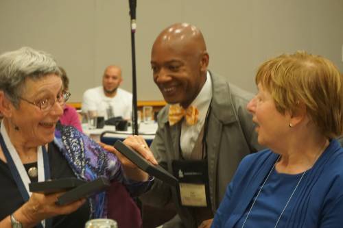 Honoree Katharine Doob Sakenfeld (left) receives a new Theological Education Fund scarf from Paul Roberts, president, Johnson C. Smith Theological Seminary, Atlanta, as her sister, Joanna Doob Nickerson, looks on at right. Photo by Emily Enders Odom.