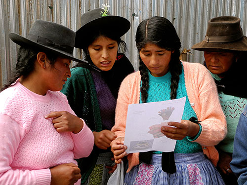 Artisans from the group Tupac Yupanki, which is supported by Partners for Just Trade, review an order. —Jessica Penner