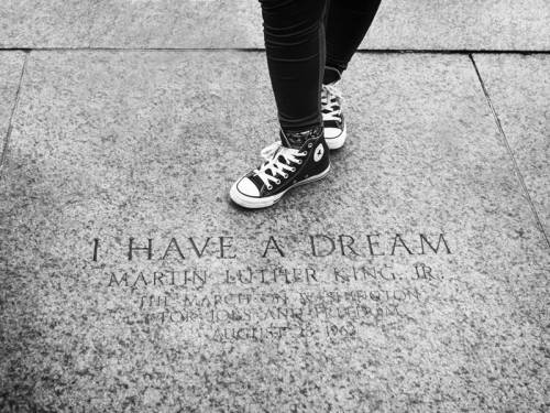 Person standing next to “I Have a Dream” MLK monument