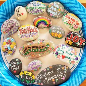 A collection of painted word rocks