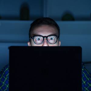 Man staring wide-eyed at a computer screen