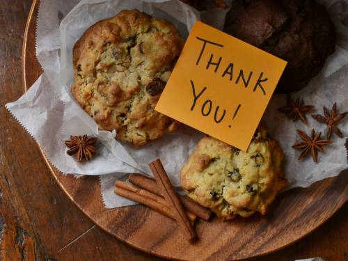 An assortment of baked goods with a tag that says Thank you!