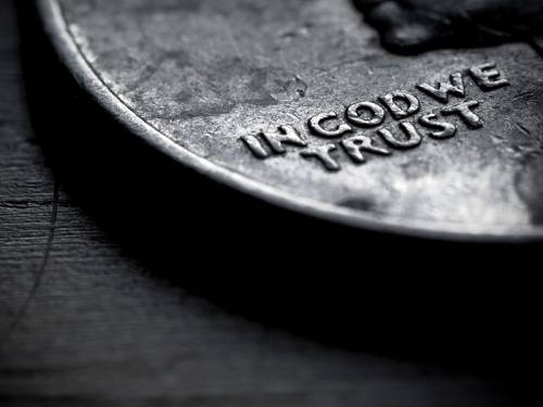 Close-up of U.S. coin showing the words "In God We Trust"