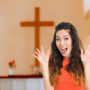 Woman in church holding up "jazz hands"