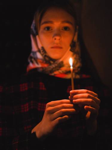 Girl holding vigil candle
