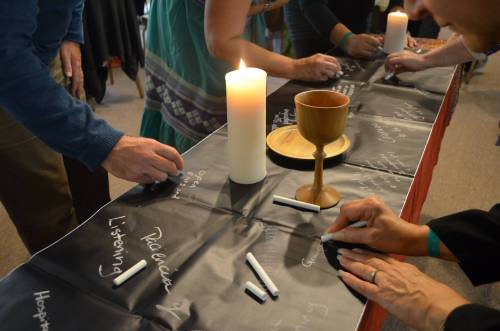 Prayers and hopes are written during communion at the conference on race, ethnicity, racism and ethnocentricity held at Stony Point Conference Center in New York. —Photo provided