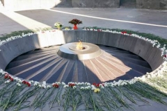Massive columns bow in mourning around an eternal flame at the Armenian Genocide Memorial and Museum. (Photo by Tanya Karimi)