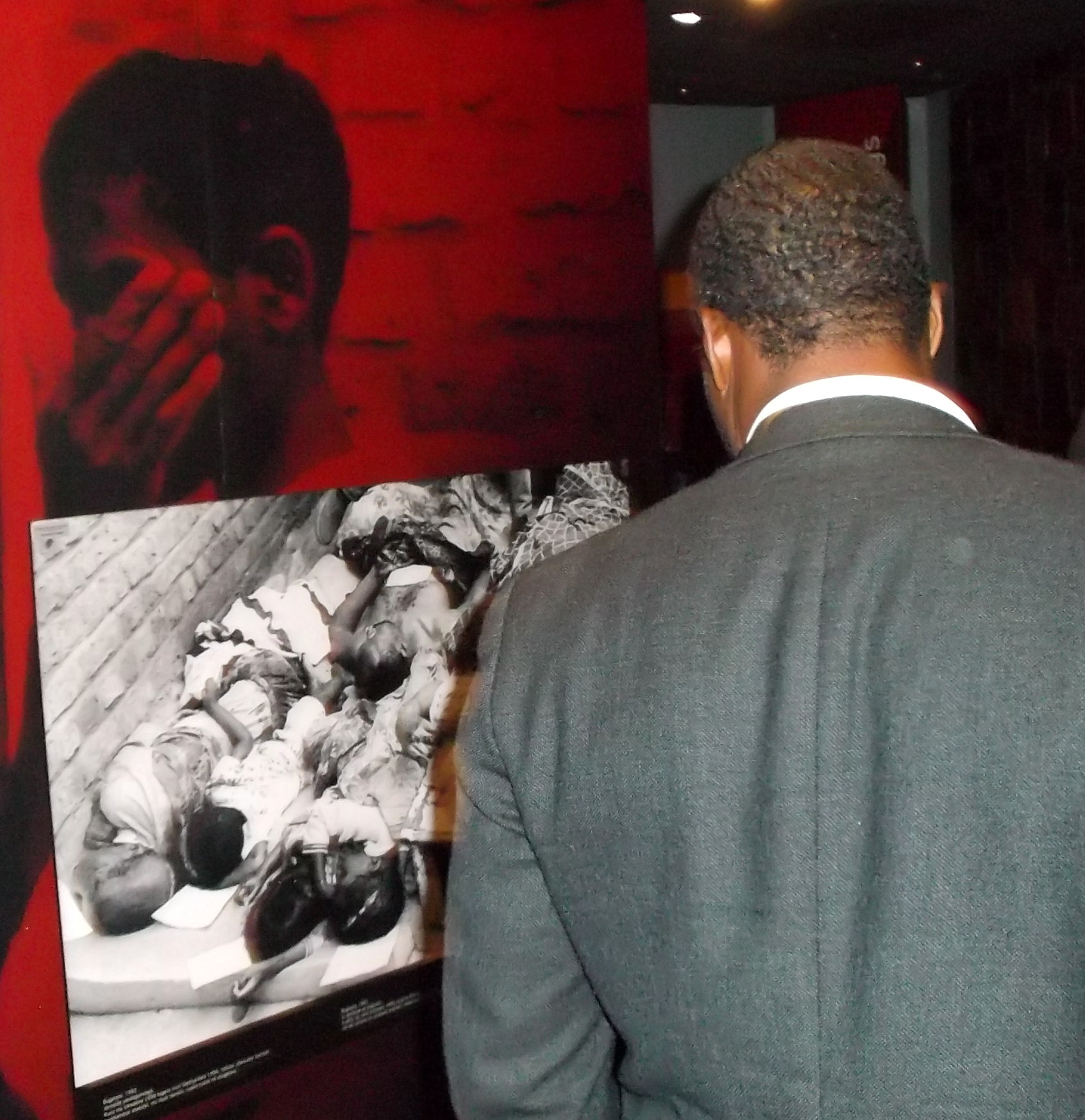Rev. Shelvis Smith-Mather looks on at some of the gruesome and telling depictions in the National Genocide Memorial.
