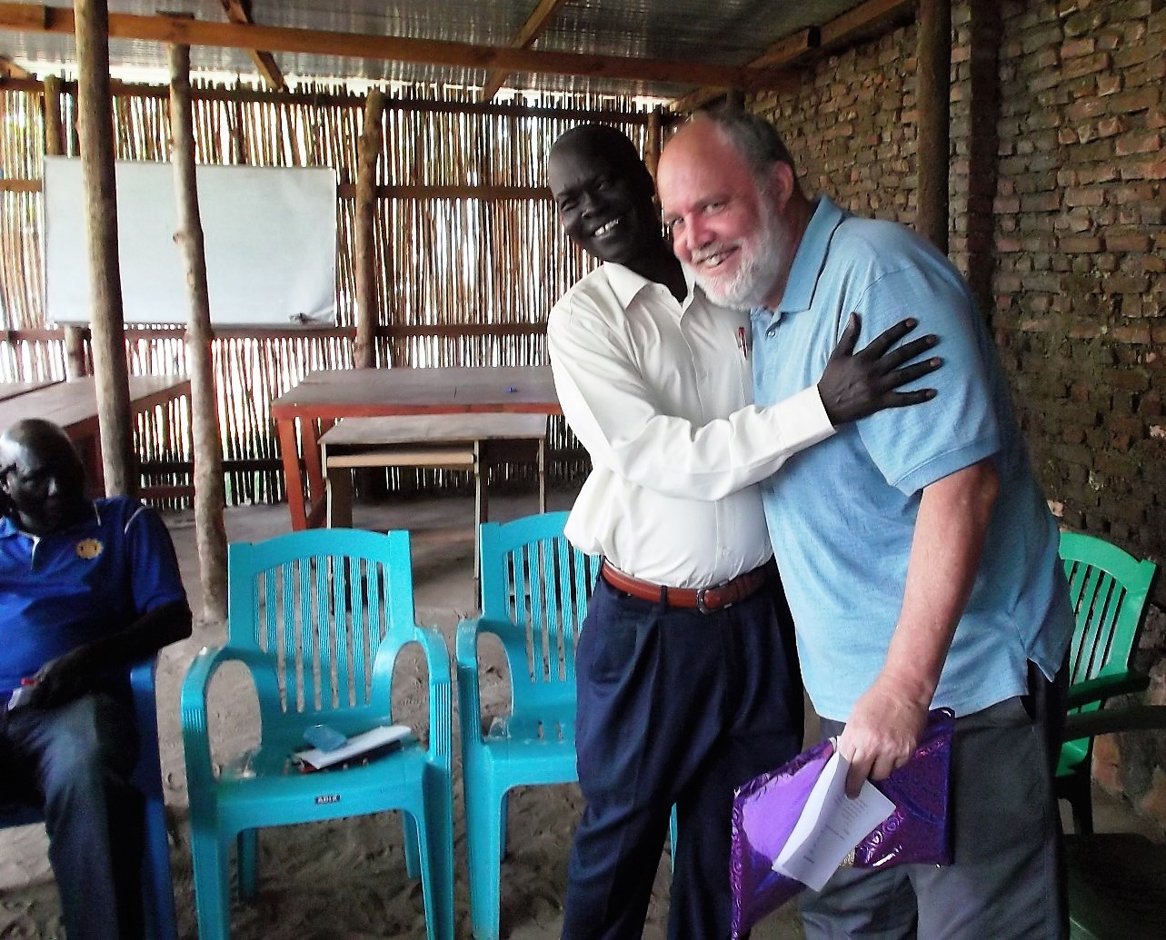 Rev. Santino, Principal at NTC, embraces Paul, our friend who came to teach an intensive course, during his farewell party.