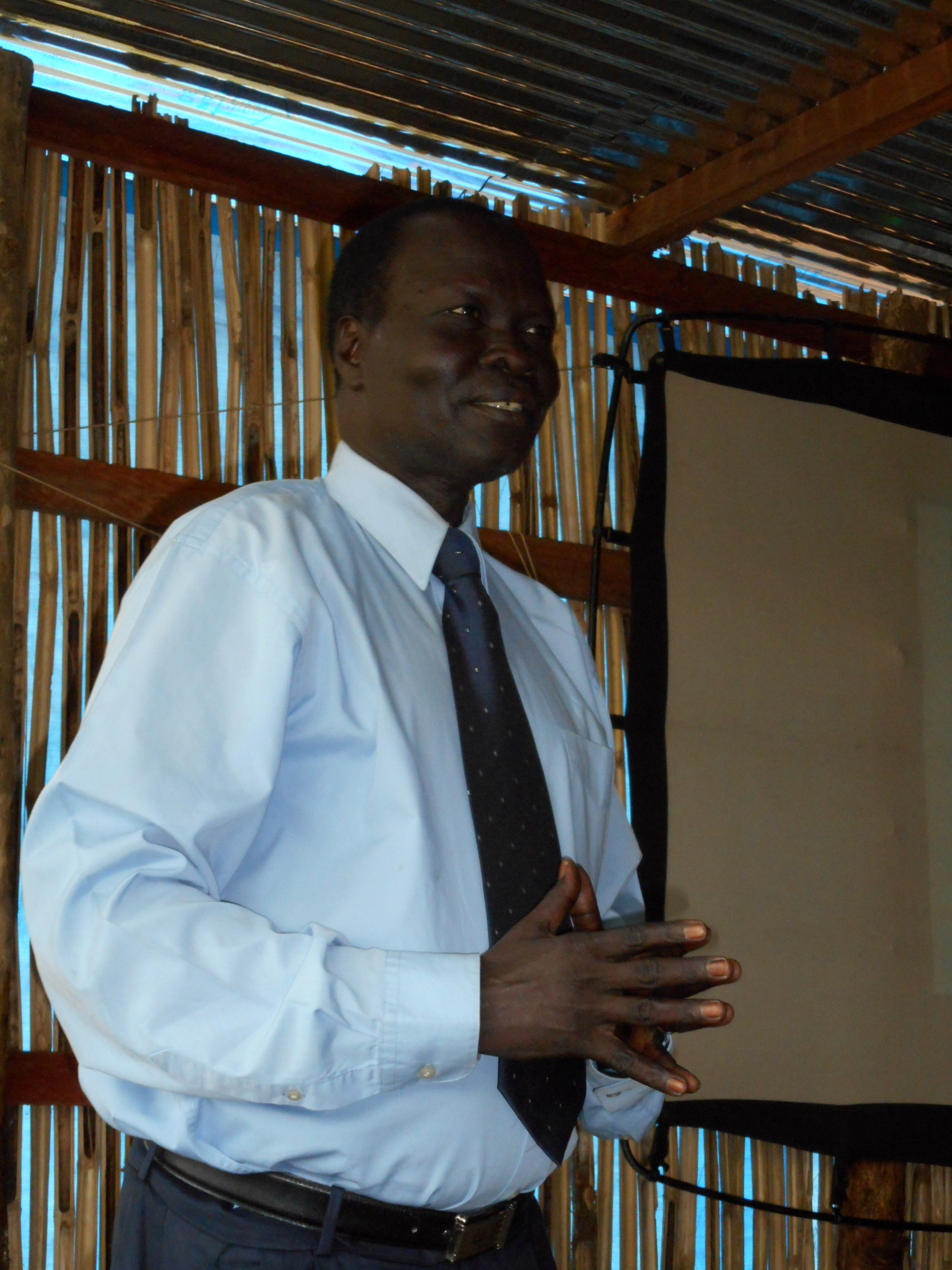 Rev. Santino, principal of Nile Theological College, shares a message of encouragement with students.