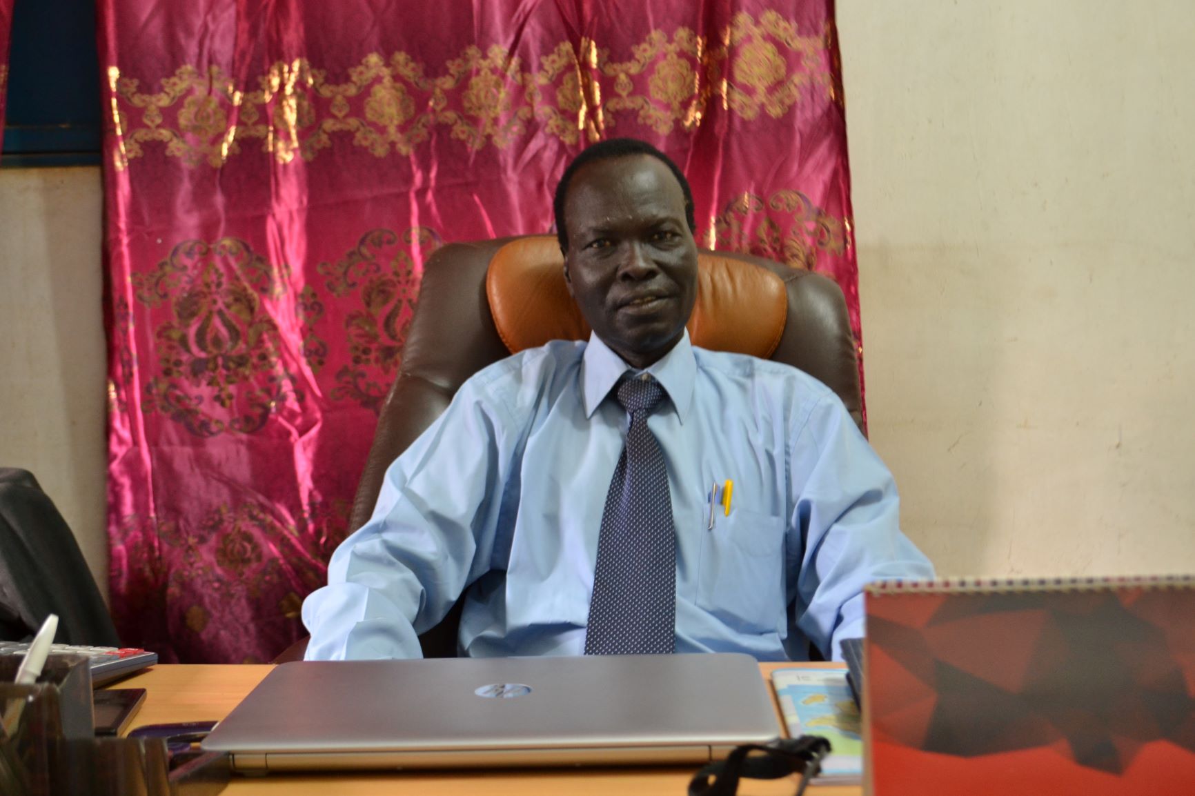 Rev. Santino at his desk at NTC in Juba.