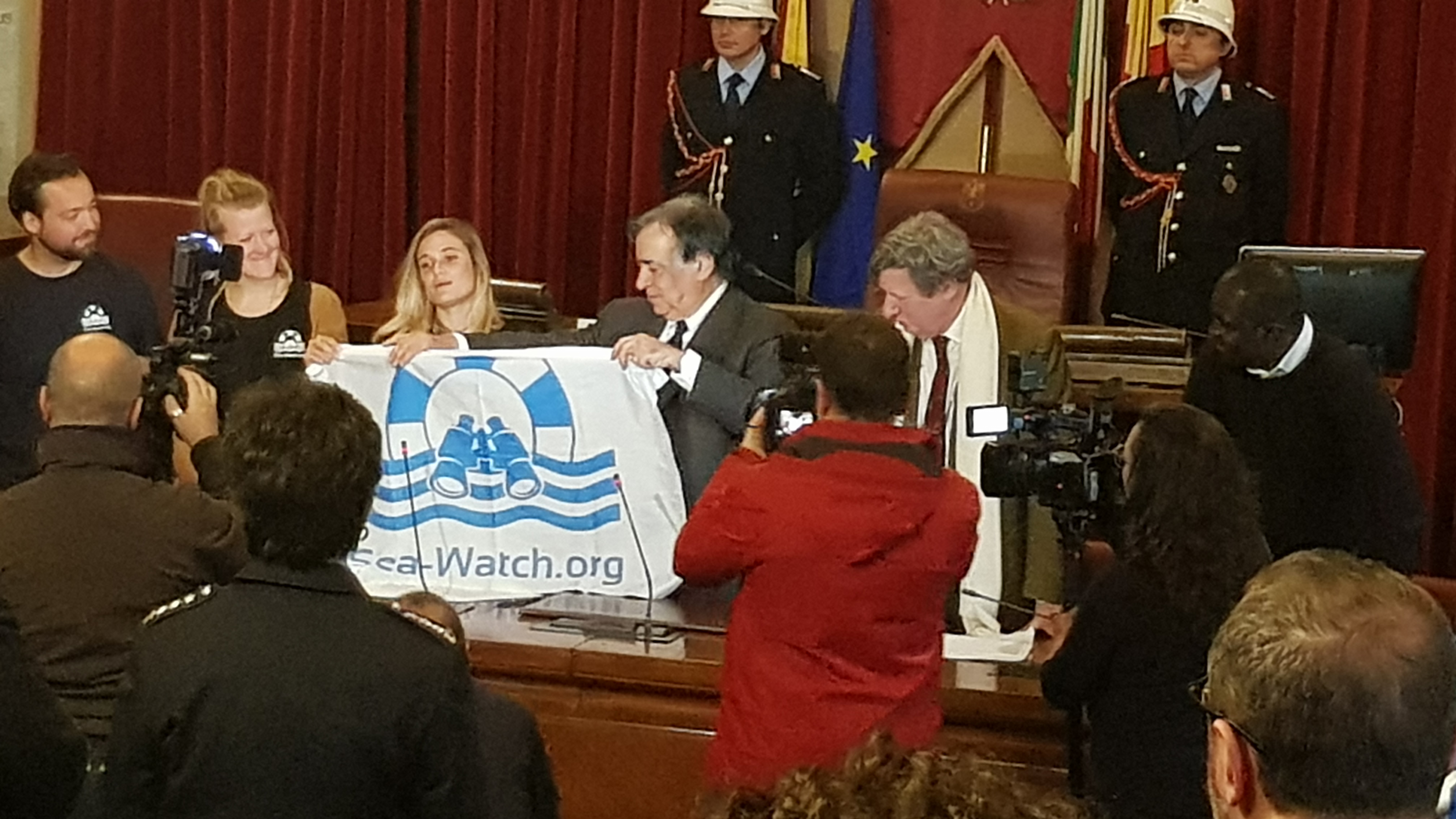 Ceremony for honorary citizenship to the crew of Sea Watch in the city hall of Palermo. Mayor Leoluca Orlando (center) and Johannes Dohnanyi (right).