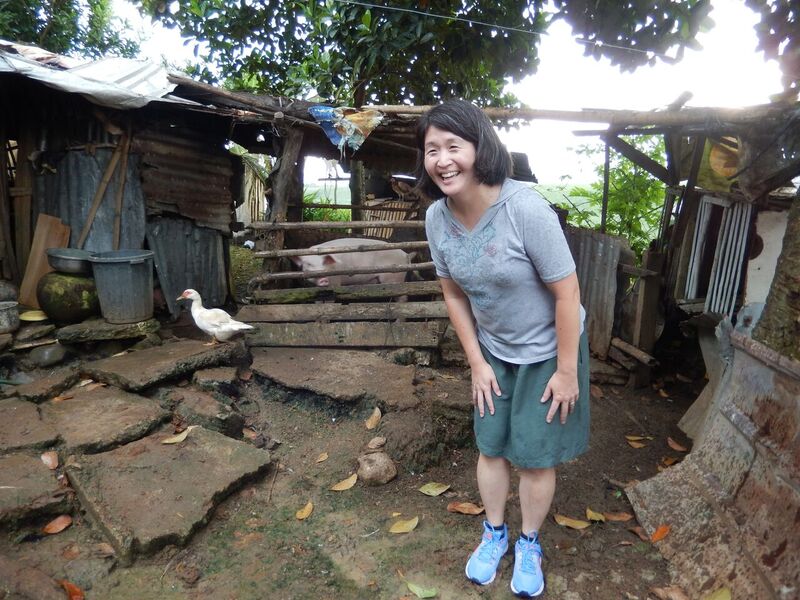 On a recent visit to southern Philippines with staff from Presbyterian Disaster Assistance, mission co-worker Cathy Chang, regional facilitator for addressing migration and human trafficking in Southeast Asia, enjoys a lighthearted moment with a healthy pig. Photo credit: Laurie Kraus