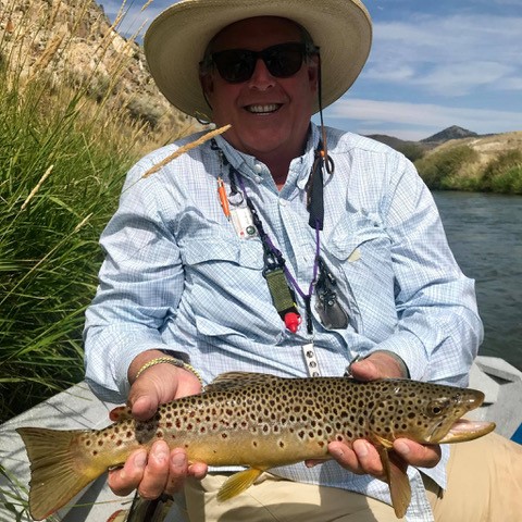 Charles finding his joy with a big brown trout in his favorite place - Montana.