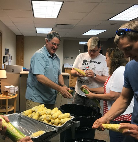 Charles helps shuck corn for the potluck dinner before our presentation at the Westminster Presbyterian Church, Waterloo, IA.