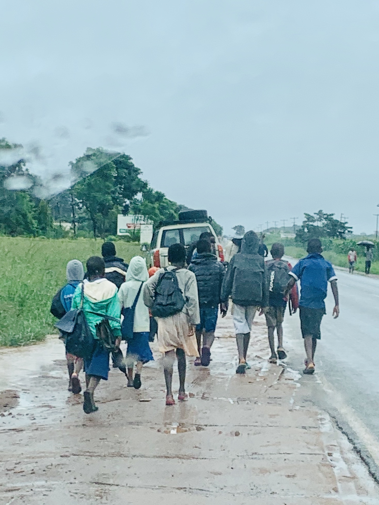 Malawian children walking to school in the rainy season. (Photo by Cheryl Barnes)
