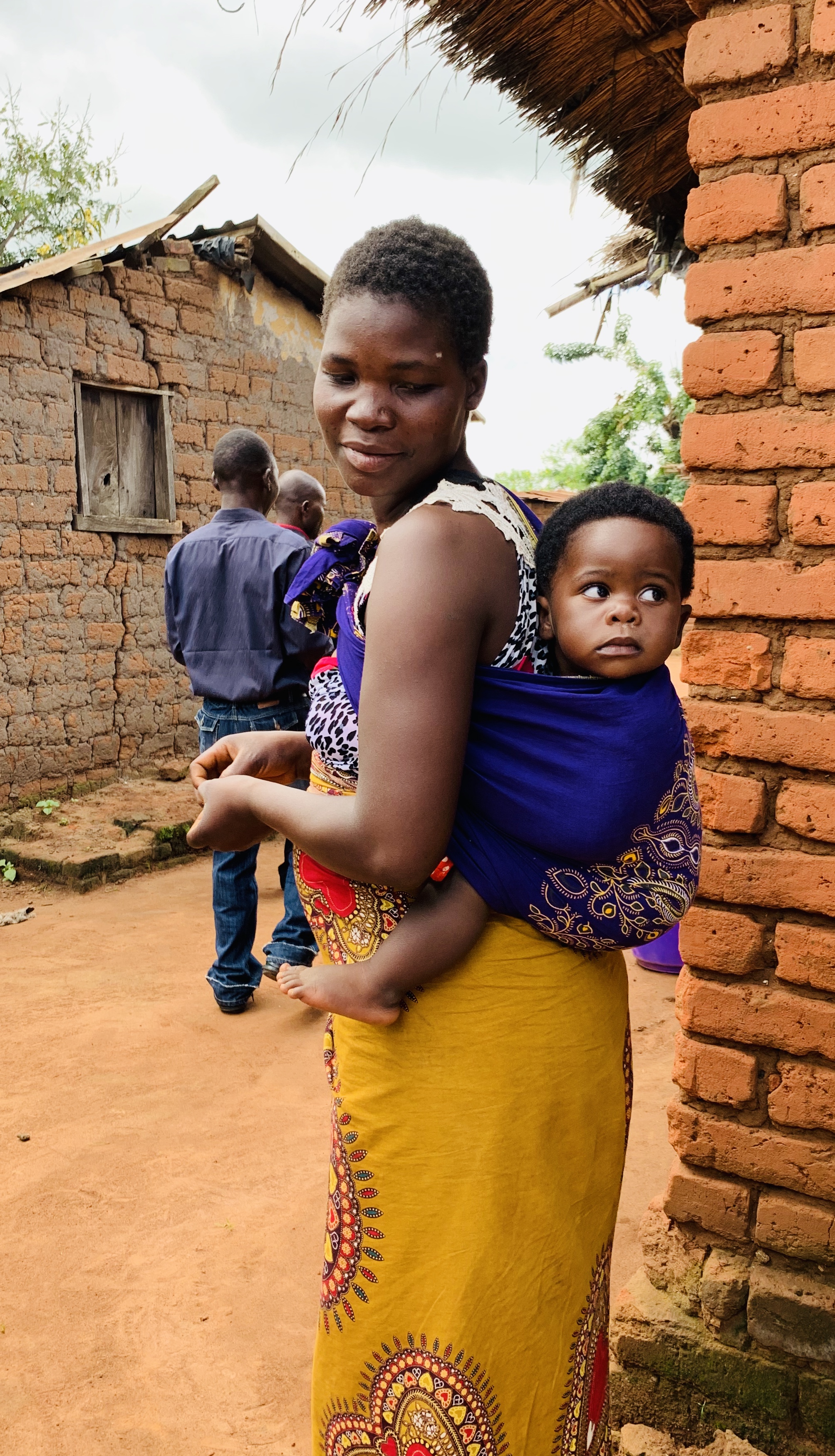 Malawian mother carrying baby in chitenge fabric. (Photo by Cheryl Barnes)