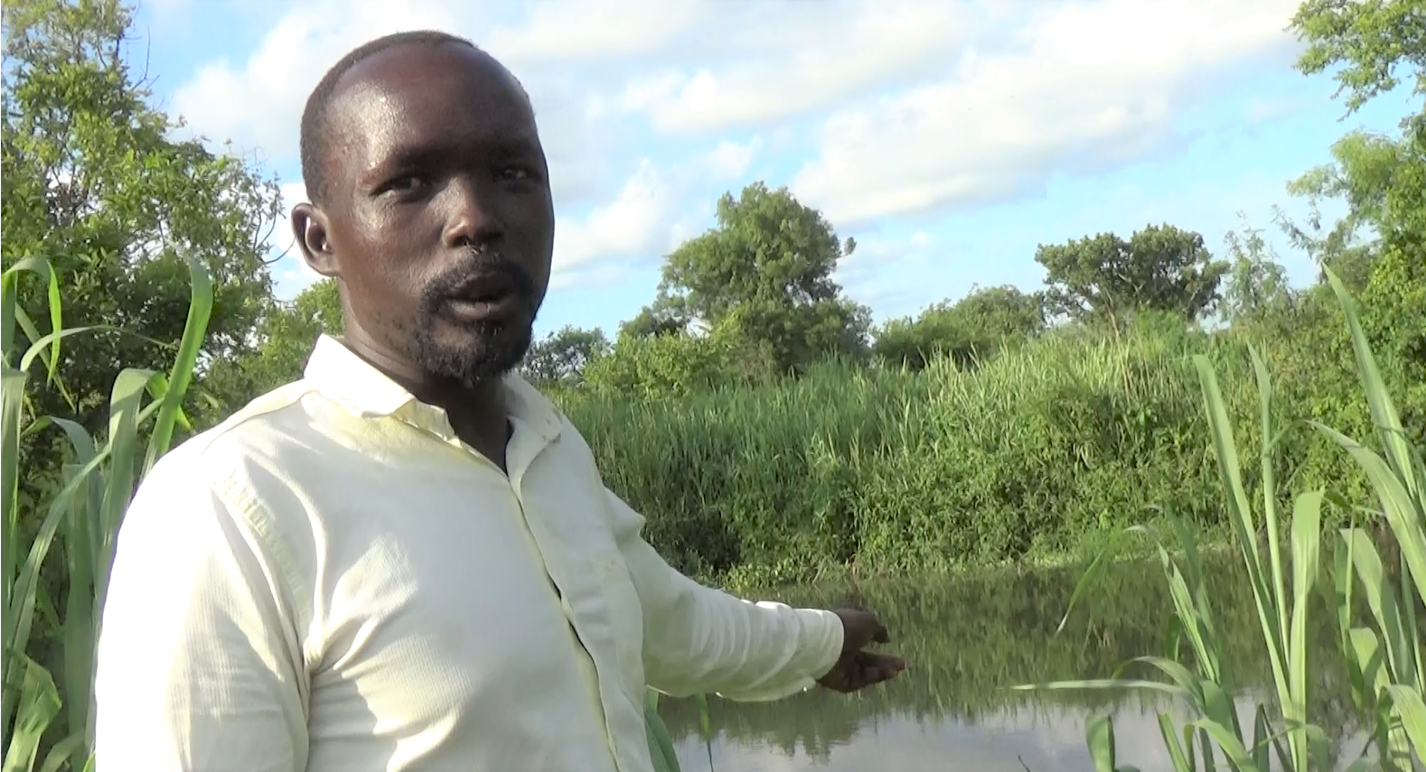 Standing on the edge of the school demonstration farm, Othow points to the Akoba River, which nourishes the plants during the dry season.