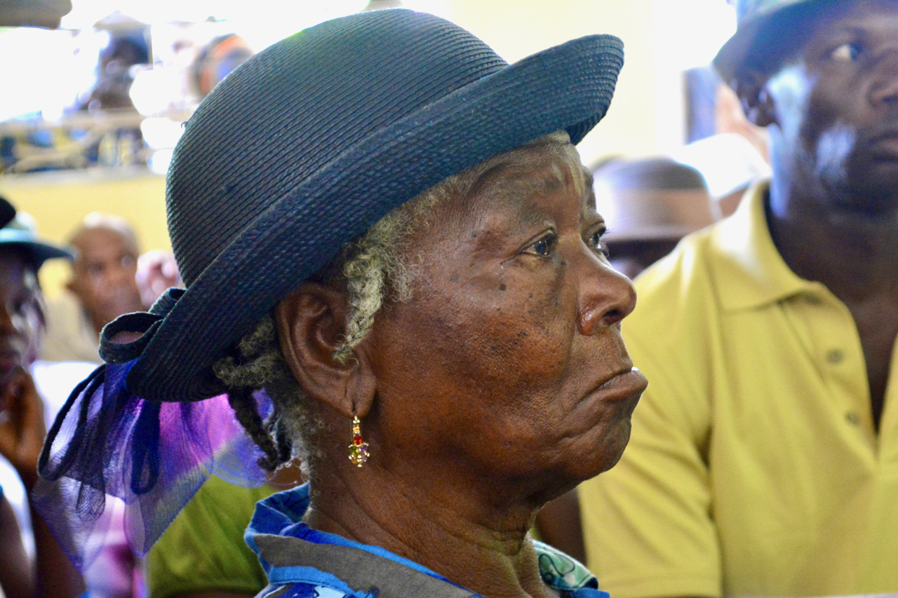 A woman listens during a training session in Camp Perrin, Haiti, as part of a project funded through Presbyterian Disaster Assistance.