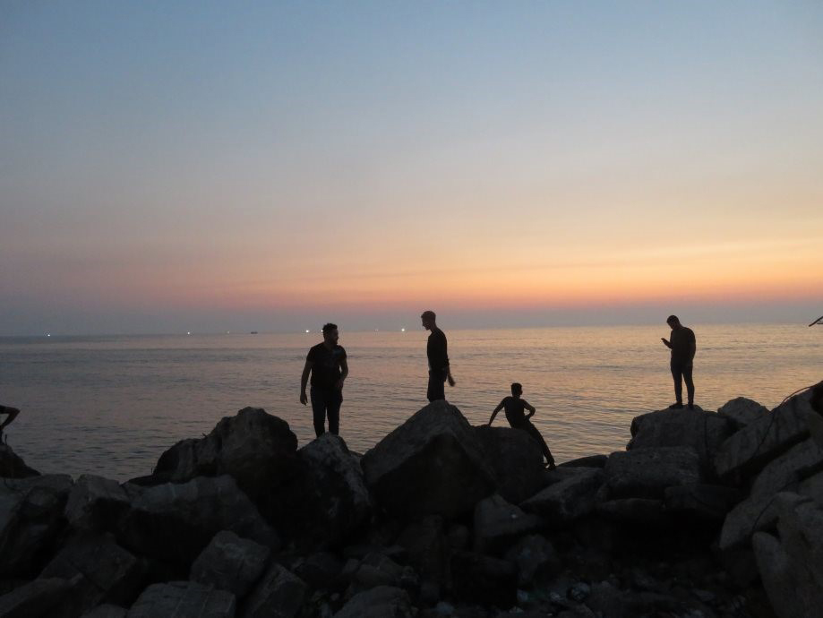 Young Gazans gather at the seaside at sunset. What must they be dreaming of?