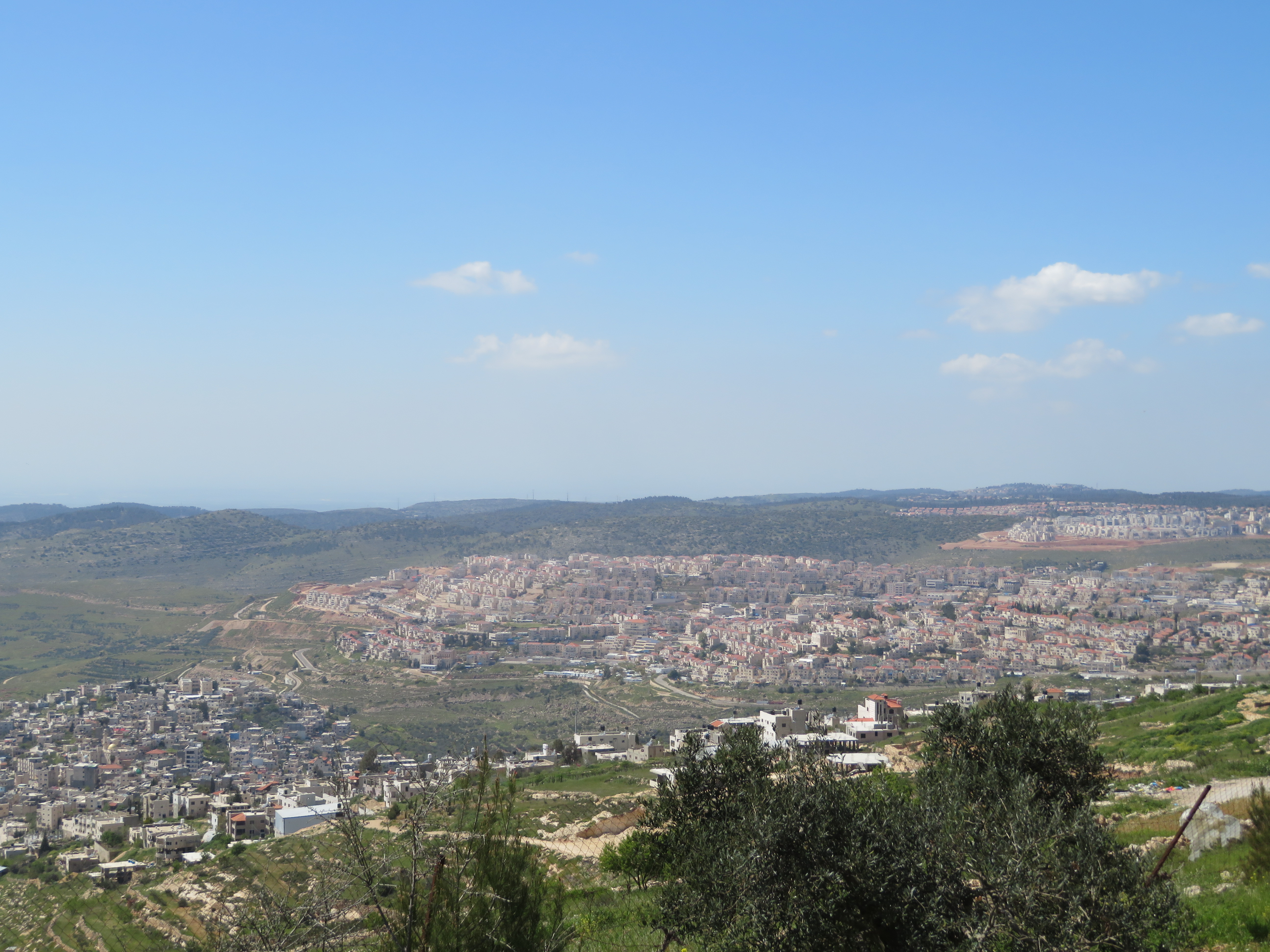 A view from the Tent of Nations farm towards the southwest. The Palestinian village of Nahalin lies in the valley to the left, while the Israeli settlement of Beitar Illit commands the hilltop on the right. Photo: Doug Dicks