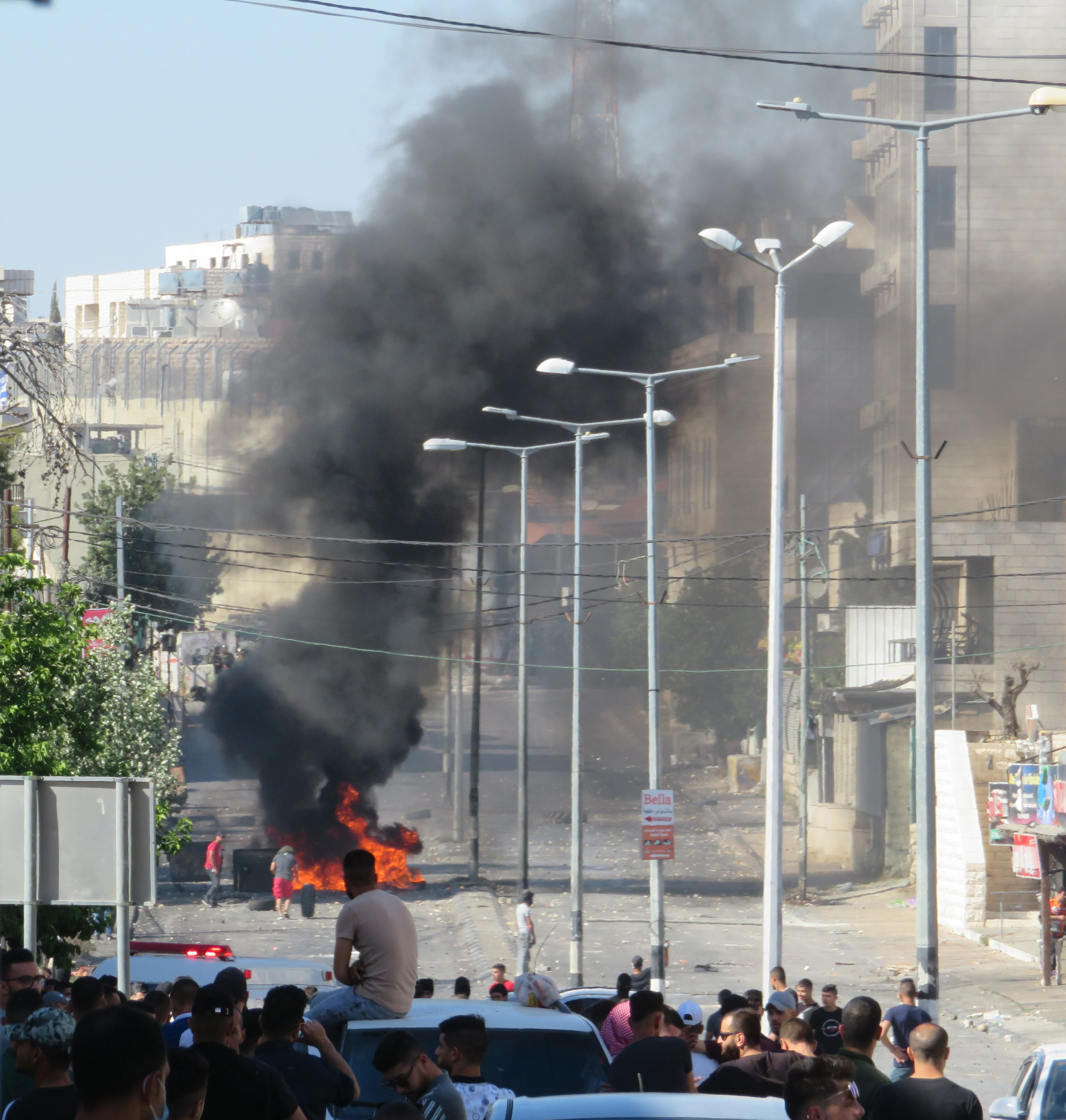 Palestinian youth burn tires in the streets of Bethlehem following an encounter with Israeli troops near Rachel’s Tomb.