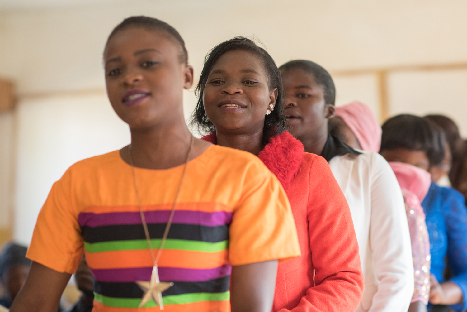 A Justo Mwale women’s choir sings a chorus in chapel, while dancing their way forward to sing the main song.