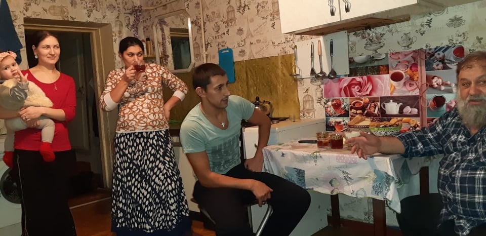 Andrey shares tea and fellowship with a local family.