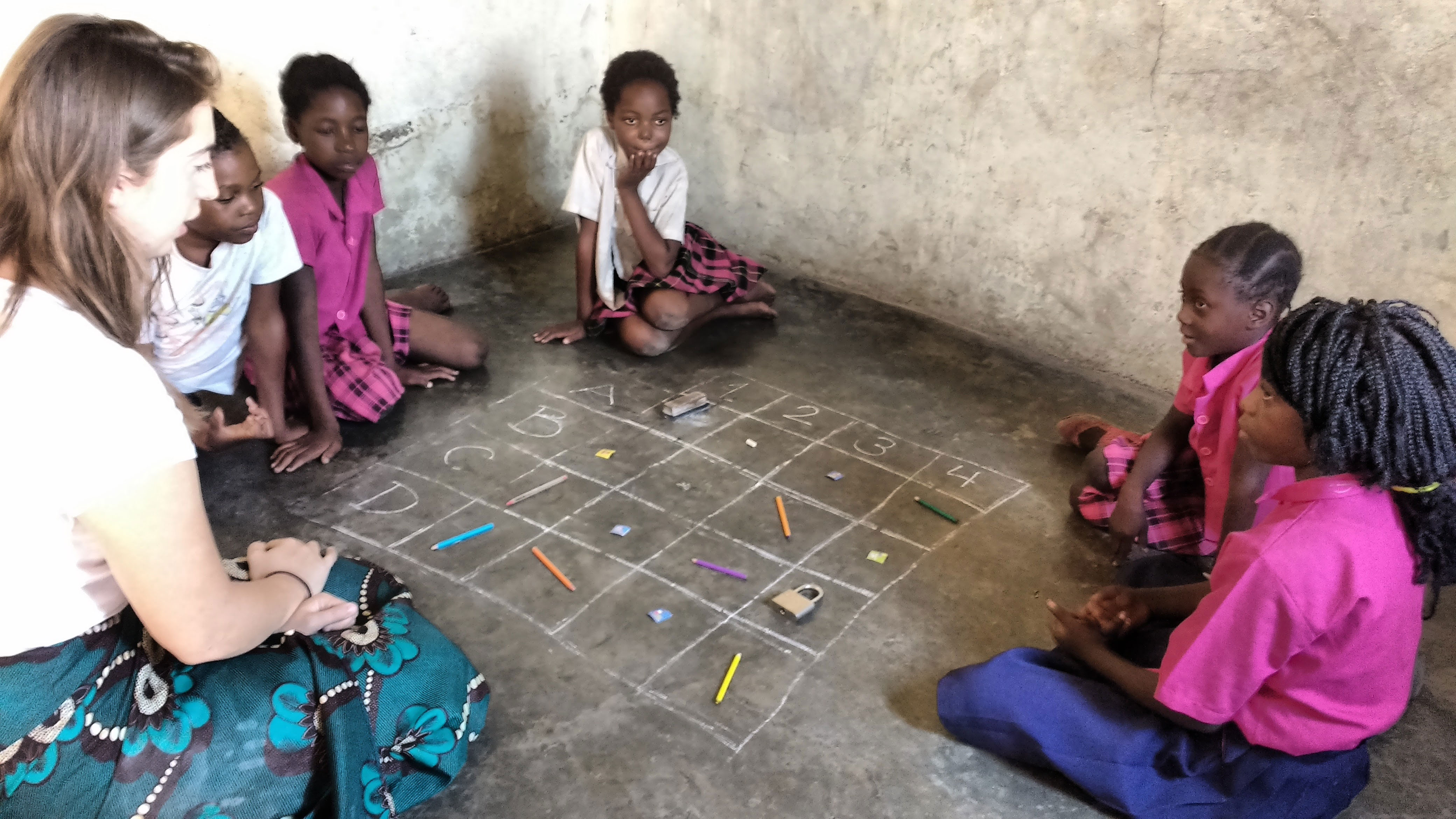 YAV Olivia teaching about grids on the floor of her classroom