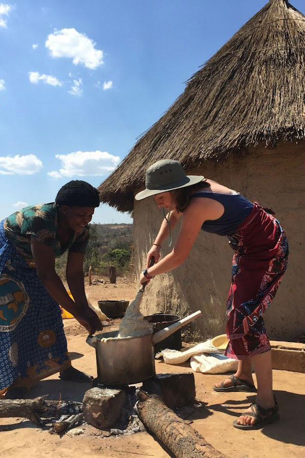 Emily and Mabuchi cooking nshima during YAV Zambia orientation