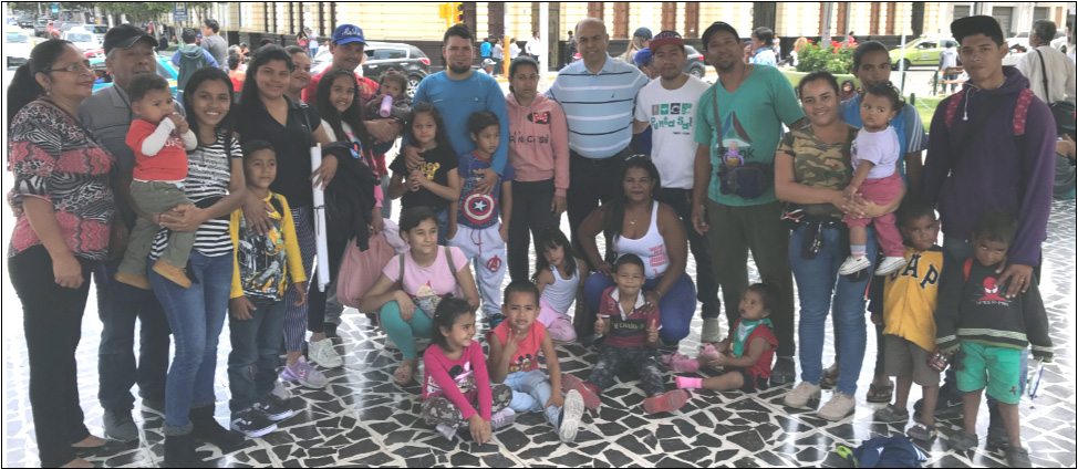 Pastor Pedro Bullón (top center, striped shirt) gathers with refugees who recently arrived by foot from Venezuela near the northern border of Peru. (Photo credit: Jed Koball)