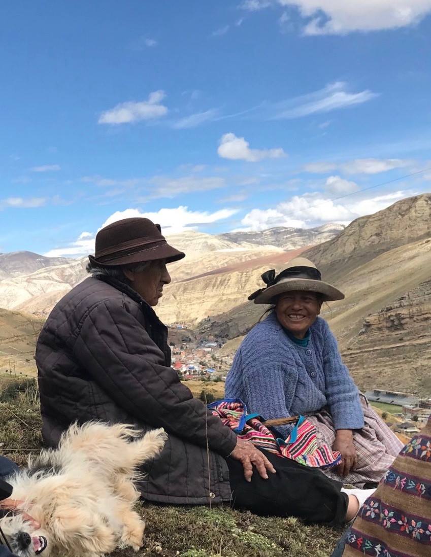 Victoria Trujillo, better known as ¨Mama Toya¨ sits with her friend on the hillside of the communal land they share. (photo by Jed Koball)