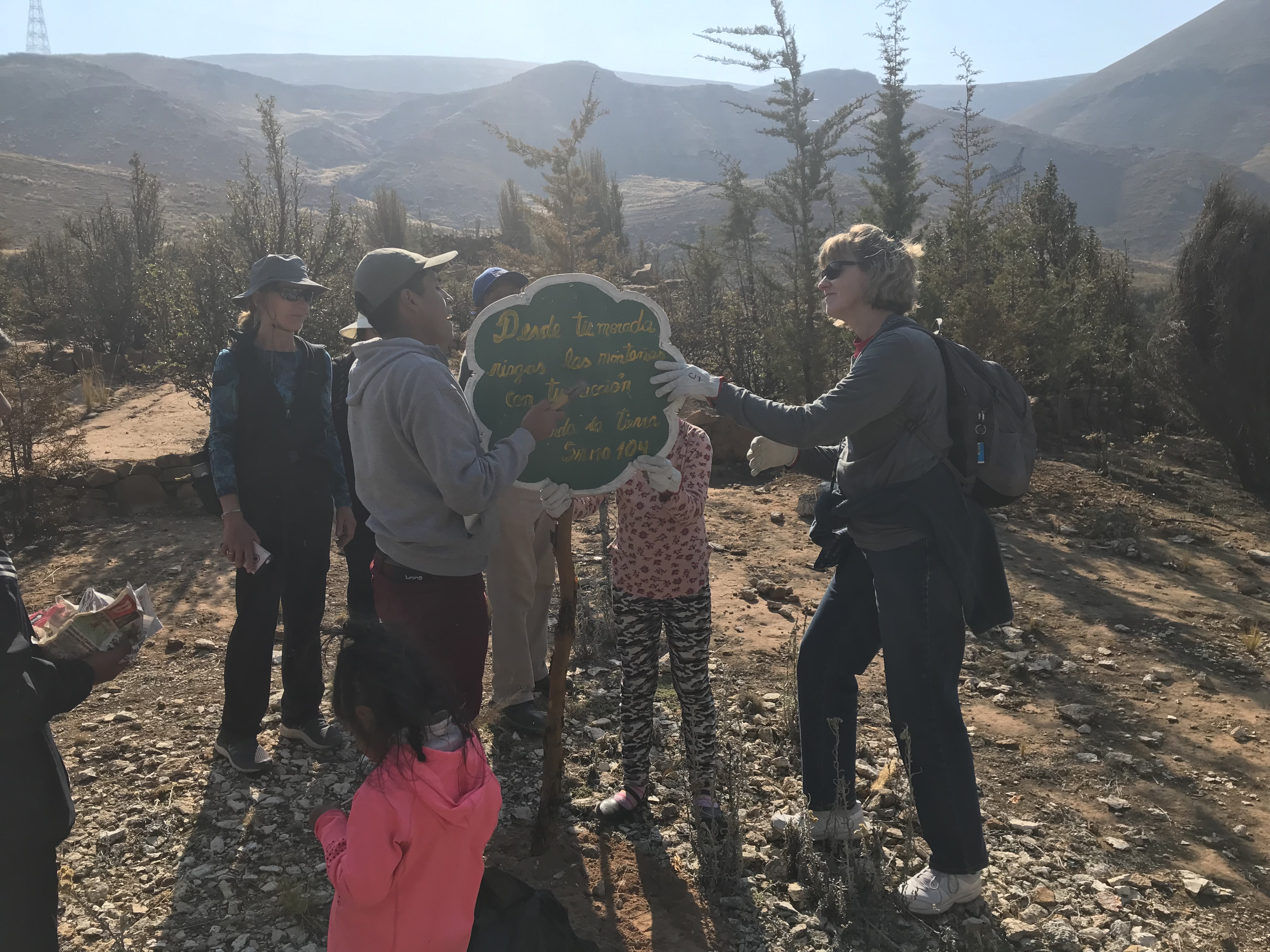 Chris Turner of Covenant Presbyterian Church helps newer members of the Conservation Committee place inspirational signs on the land of Villa El Sol. This sign quotes Psalm 104.