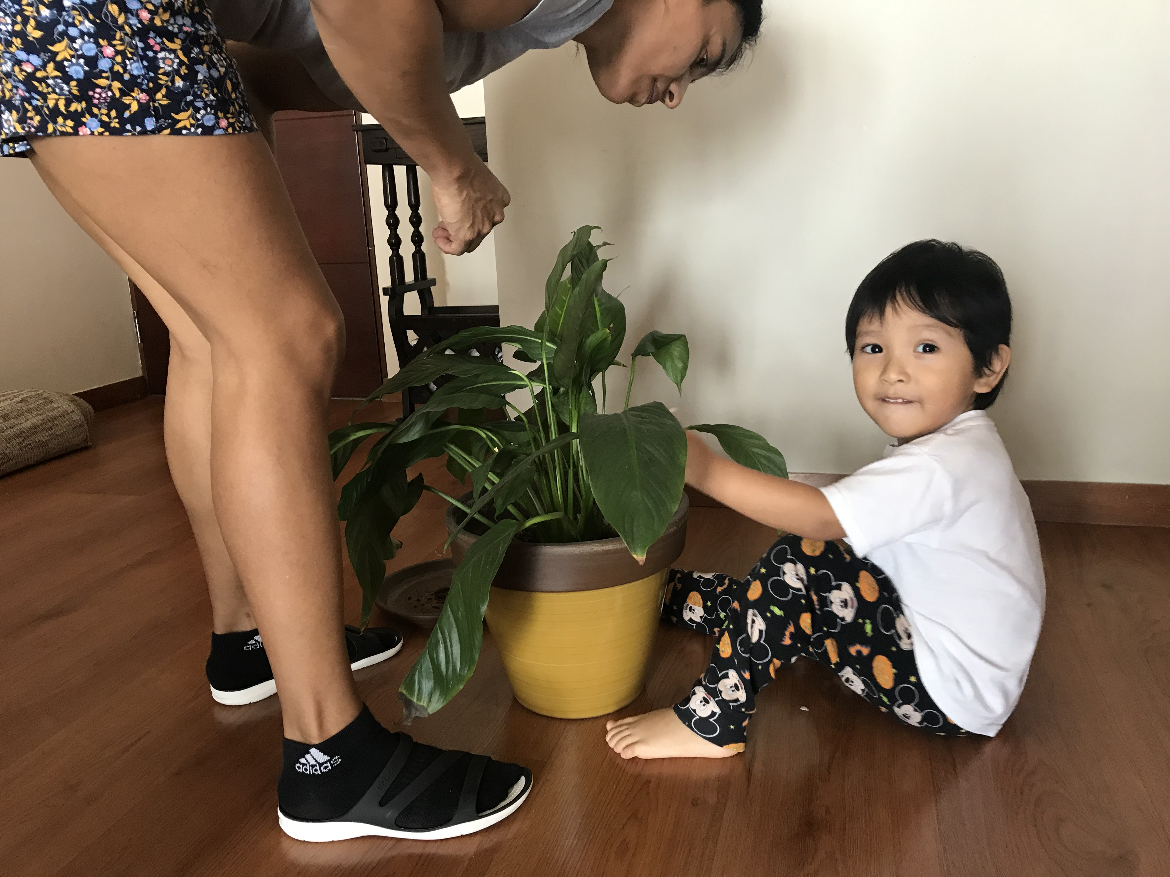 Jenny teaches her son Thiago about tending to the soil.