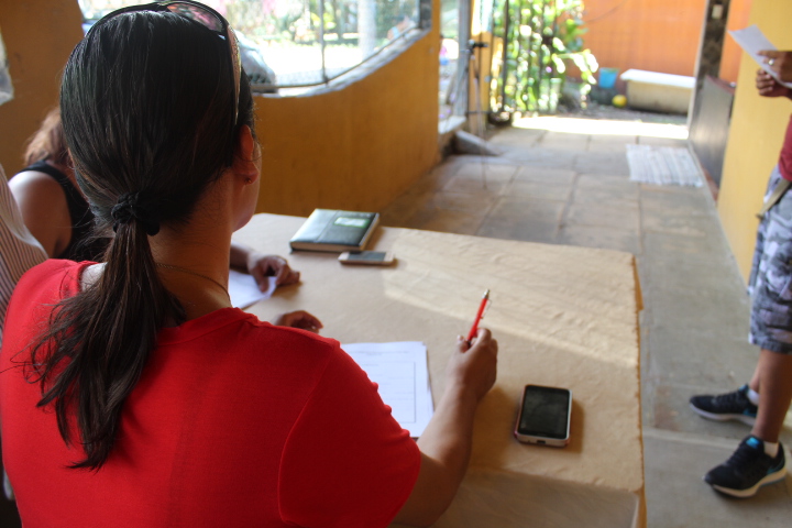 A volunteer helping refugees get registered to request asylum in Costa Rica.