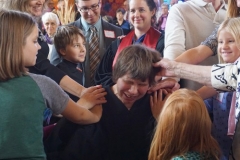 Children lay on hands at Lisa Larges’s ordination on Sunday, Oct. 30, 2016; Ben Masters and Kara Root in background. (Photo by Emily Enders Odom)