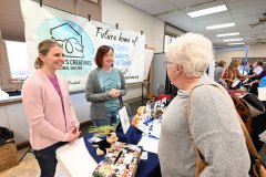 Volunteers with All God's Creatures, a program initiated by First Presbyterian of Mt. Pleasant, talk to church members at a Matthew 25 fair. (Rich Copley | PCUSA)